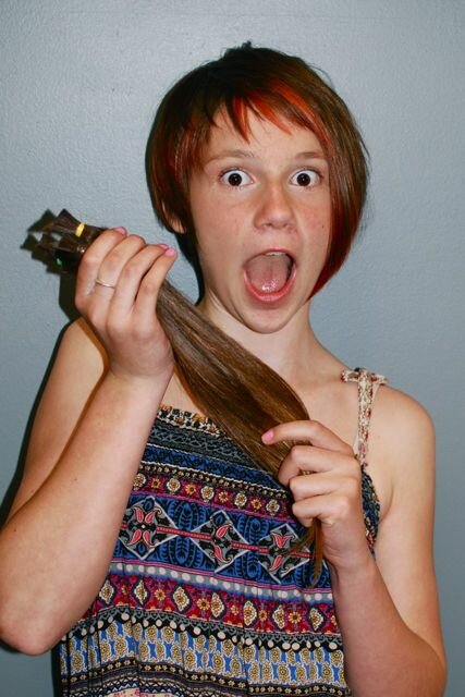 Kelsey holding cut hair Kelsey holding cut hair